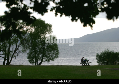 Enjoying a picnic in solitude on Lake Tarawera North Island New Zealand Stock Photo