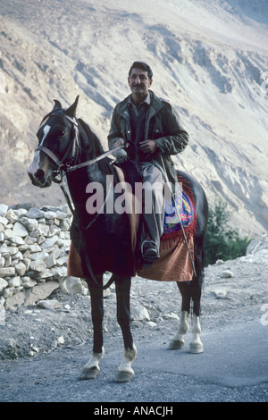 Pakistan Karimabad Hunza Village Man on Horse Batura Glacier Stock Photo