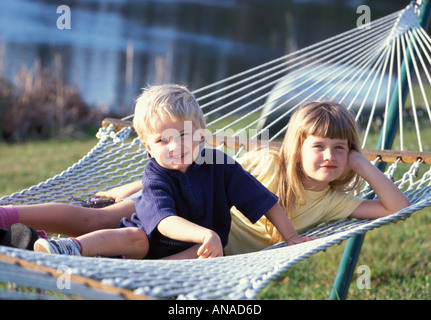 Boy and girl on hammock Stock Photo