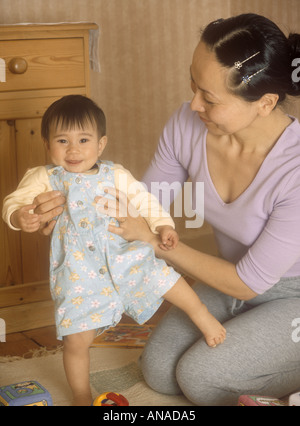 Japanese mother teaching her baby girl to walk Stock Photo