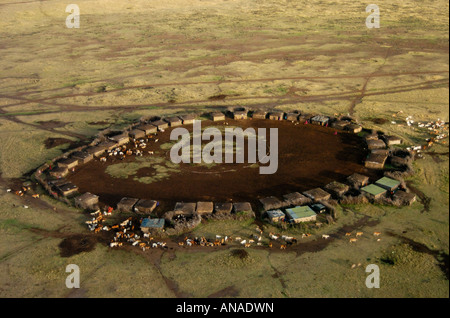 Aerial view of a traditional Maasai manyatta with cattle moving out to grazing pastures Stock Photo