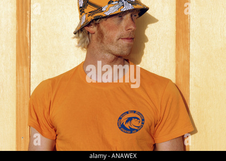 joung blond man standing in front of a wall Stock Photo