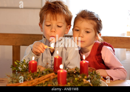 Children in the christmas time with candles and advent wreath Stock Photo