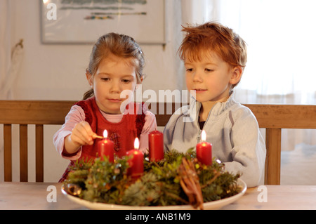 Children in the christmas time with candles and advent wreath Stock Photo