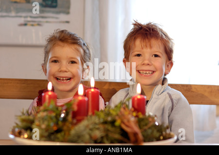 Children in the christmas time with candles and advent wreath Stock Photo