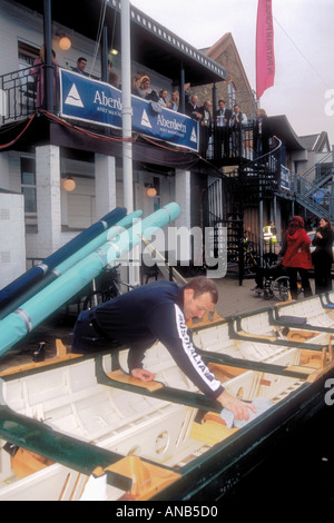 Preparing a replica Victorian rowing shell at the Oxford and Cambridge Boat Race at Putney Surrey near London England UK Stock Photo