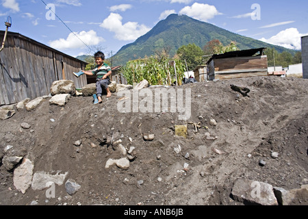 GUATEMALA PANABAJ Guatemalan boy with rubber boots in the village of Panabaj destroyed by mudslides Stock Photo