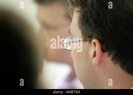 THREE MEN IN AN OFFICE MEETING Stock Photo