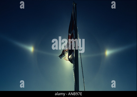 Sundogs behind British flag flying in Antarctica Stock Photo