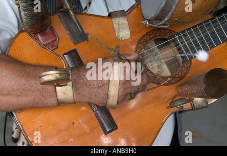 Man playing guitar and mouth organ at fiesta on Gran Canaria Stock Photo