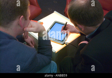 two men working with tablet PC Stock Photo