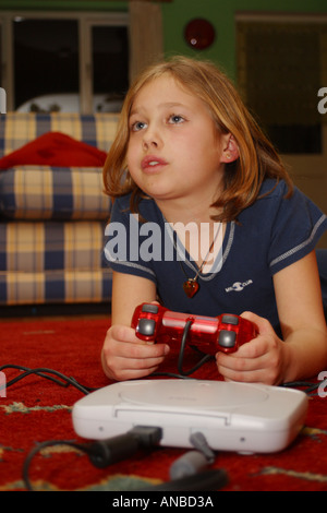 Young girl engrossed with playing her playstation computer game Stock Photo