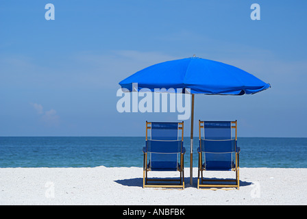 Empty lounge chairs overlooking a quiet ocean view, on the beach of Sand Key Beach, FL. Stock Photo