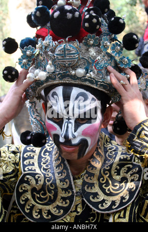 A male Chinese opera singer prepares for an outdoor performance near the lake of Silver Dollar Village in Shanxi Province. Stock Photo