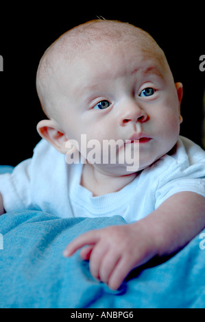 Three month old baby looks up at the world around him Stock Photo