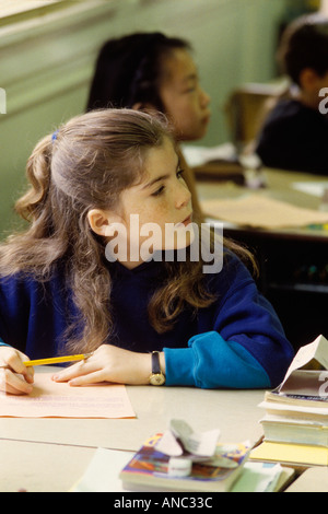 H00017 tif Fourtth grade studebt working at desk in classroom Stock Photo