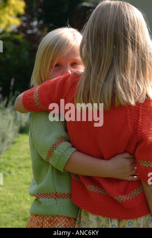 kids walking with their arms around each other into the dark forest ...