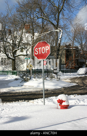 Stop sign and hydrant buried in snow after a big storm Stock Photo