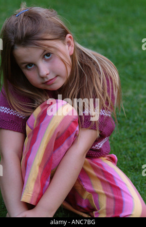 Portrait of sad girl sitting on sofa Stock Photo - Alamy