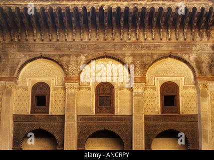 Stucco and cedar wood decorations on walls in courtyard at Medersa Bou Inania Fez Morocco Stock Photo