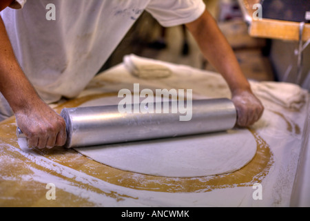 How to make pizza it starts with rolling out the dough Stock Photo