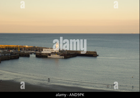 Scarborough beach and lighthouse at sunset, North Yorkshire, UK Stock Photo