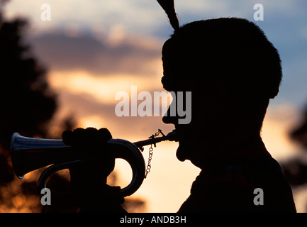 Silhouette of a man playing a bugle Stock Photo
