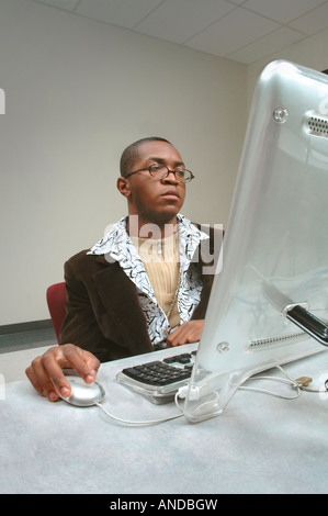 Black African American artist or art student working or browsing the Internet on a MacIntosh computer Stock Photo