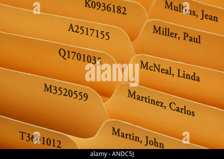Tabs of manilla file folders on people or personnel Stock Photo