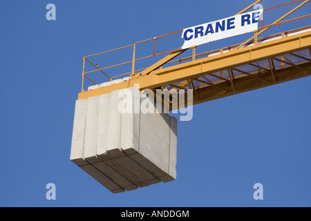 Tail end of tower crane horizontal arm with concrete balancing weights. Proprietary details deleted. Stock Photo