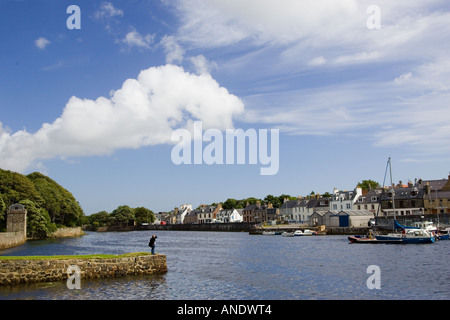 Man looks over at Stornoway harbour Outer Hebrides United Kingdom Stock Photo