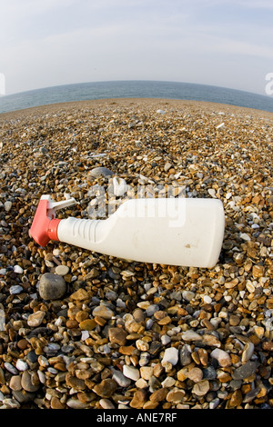 Plastic spray bottle discarded on Cley Beach Norfolk United Kingdom Stock Photo