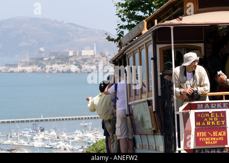 San Francisco Cable Car or Trolley on a Hill Overlooking Alcatraz Prison Stock Photo