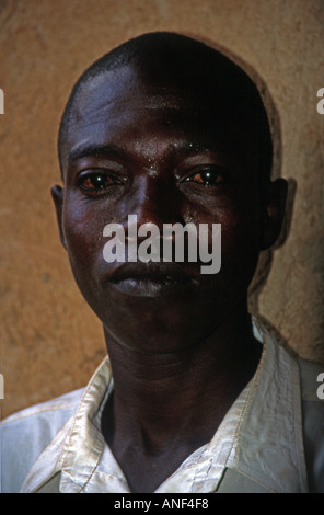 Portrait young black man of shanty town Acholy Quarter posing indoor inside wooden mud shack Kampala Uganda East Africa Stock Photo