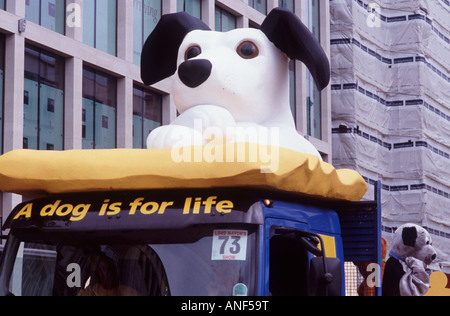 A dog is for life: Large black and white puppy with crossed paws on a dog rescue float, Lord Mayor's Show, City of London Stock Photo