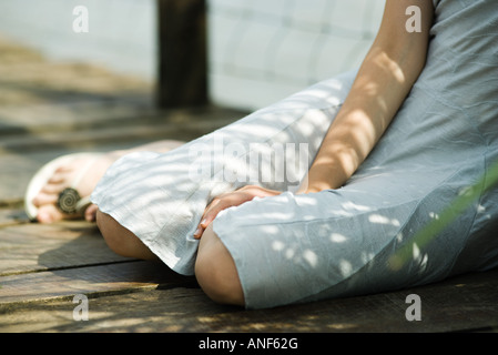 Teen girl wearing dress, cropped view, waist down Stock Photo