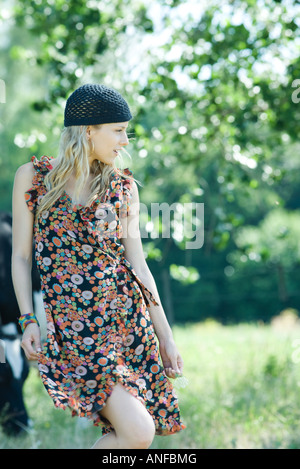 Young woman walking in rural setting, looking away Stock Photo