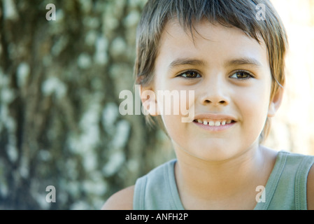 Little boy outdoors, smiling, head and shoulders, portrait Stock Photo