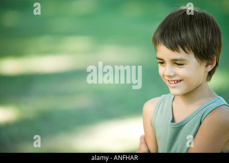 Little boy outdoors, smiling, head and shoulders Stock Photo