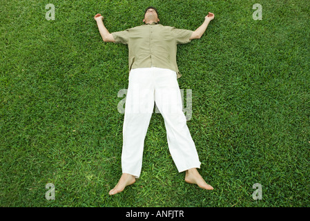 Man lying on grass, full length