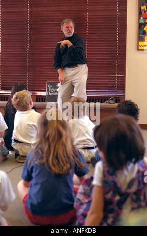 Deaf storyteller 53 signing the Ugly Duckling to children at the public library. Merriam Park Library St Paul Minnesota USA Stock Photo