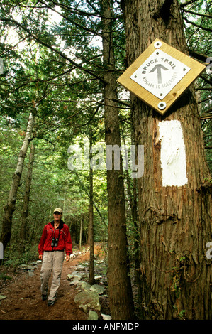 A young woman hikes on the Bruce Trail, in Bruce Peninsula National Park, Ontario, Canada. Stock Photo