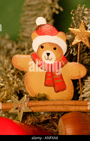 Christmas arrangement teddy bear figure in Santa Claus costume with conifer branches Stock Photo