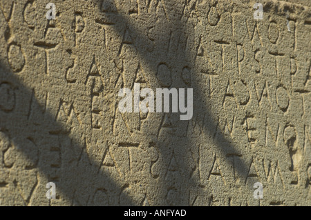 Greece Crete South Coast Gortyna archeological site close up of Stone tablets engraved with the laws of Gortyna plus casted shadows Stock Photo