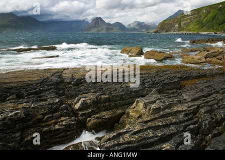 Waves Sea Surf Breaking On The Shoreline Cuilin Mountains In The Distance, Elgol Beach On The Isle Of Skye Scotland UK Stock Photo