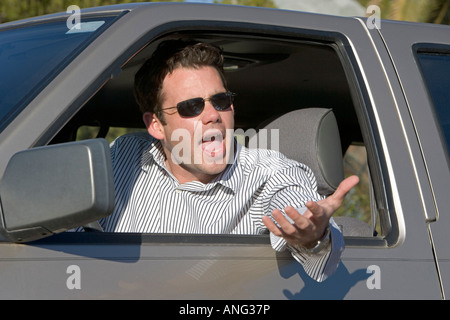 Man in his car yelling at another driver in an an example of road rage Stock Photo