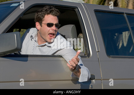 Man in his car yelling at another driver in an an example of road rage Stock Photo