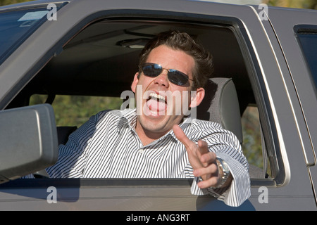 Man in his car yelling at another driver in an an example of road rage Stock Photo