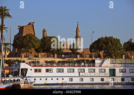 Nile cruiser vessel docked in front of Luxor Temple of Thebes located on the east bank of the River Nile in Luxor Egypt Stock Photo