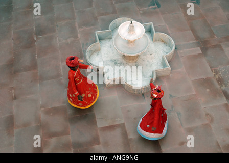 Indian children in traditional dress dancing on a sandstone street Stock Photo